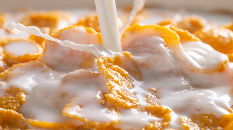 Milk being poured over corn flakes