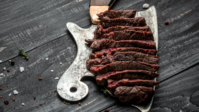 Dry aged cooked steak on wooden surface