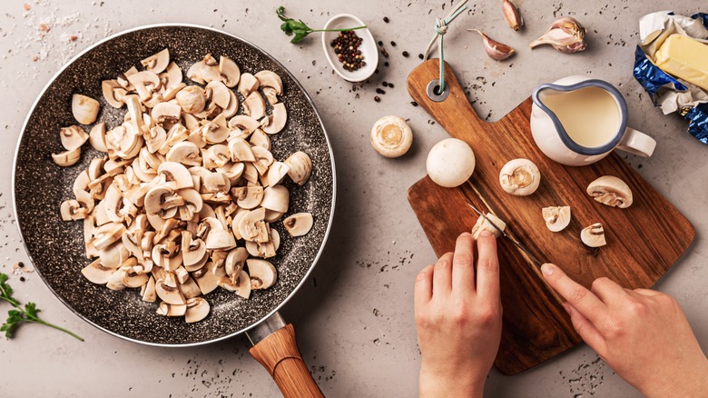 Person cutting mushrooms