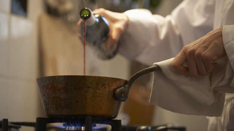 Person cooking with wine