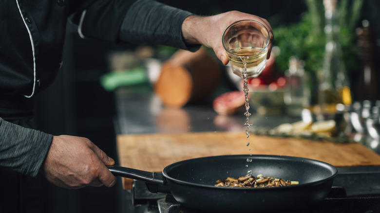 Person deglazing a pan