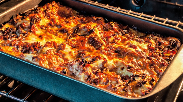 Lasagna cooking in the oven uncovered