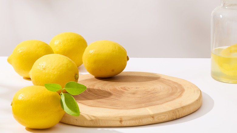 Whole lemons on cutting board