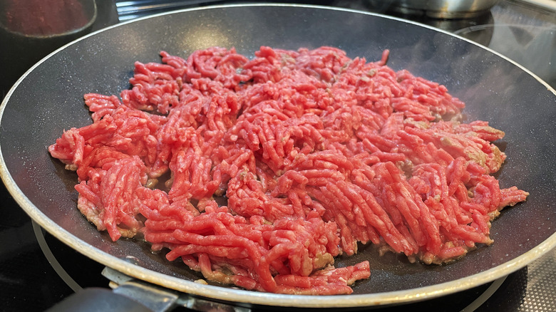 Ground beef cooking in pan