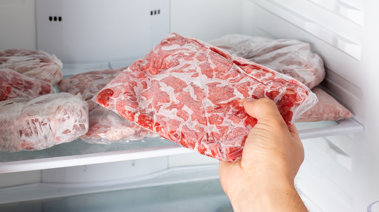 Man taking out frozen meat