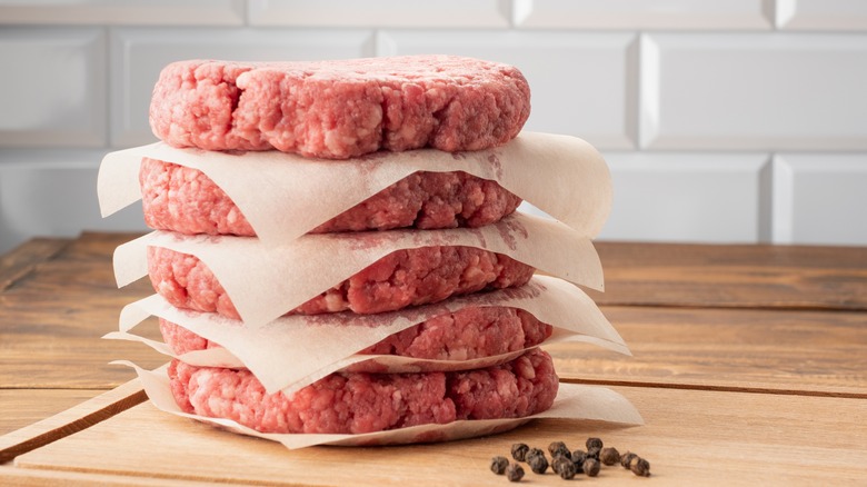 Stack of raw burgers