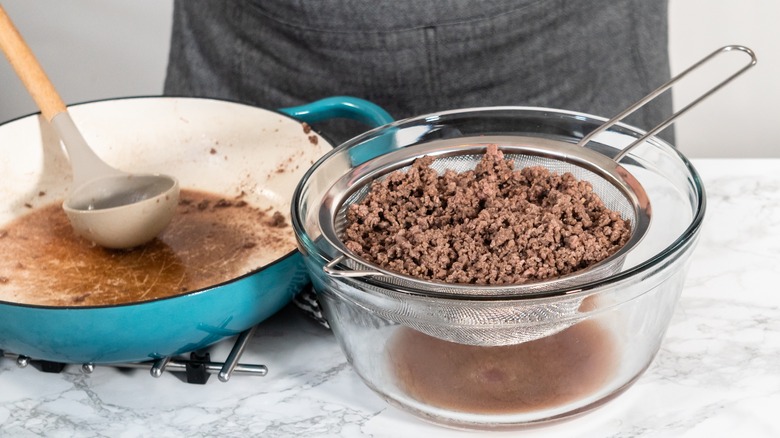 Strainer draining cooked ground beef