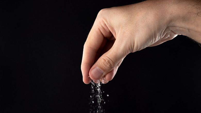 Hand sprinkling salt