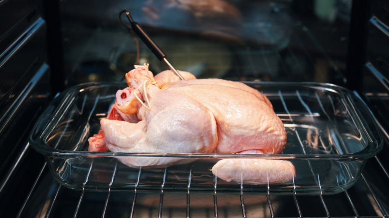 raw chicken in the oven with thermometer