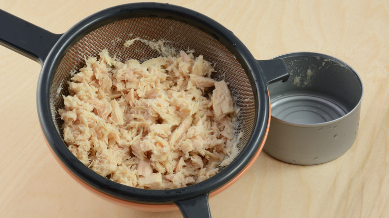 Drained tuna and empty can
