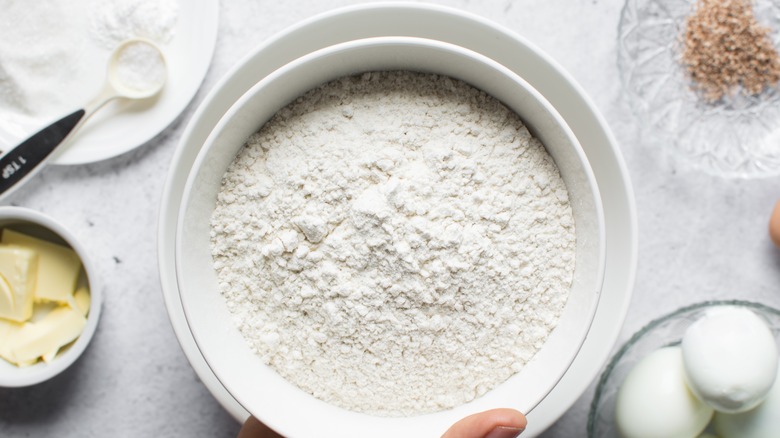 Overhead shot of flour in a white bowl