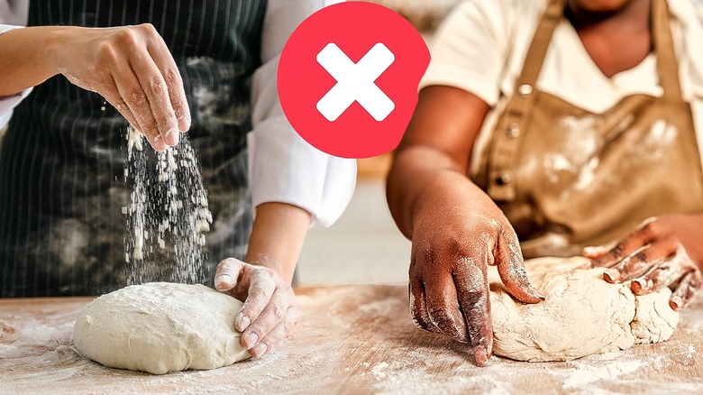 Person tearing open a loaf of bread