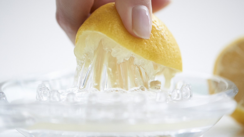 hand juicing a lemon