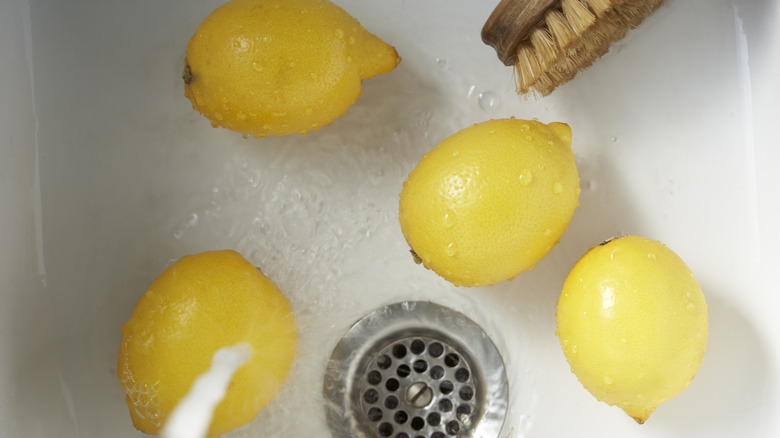 lemons being washed in sink