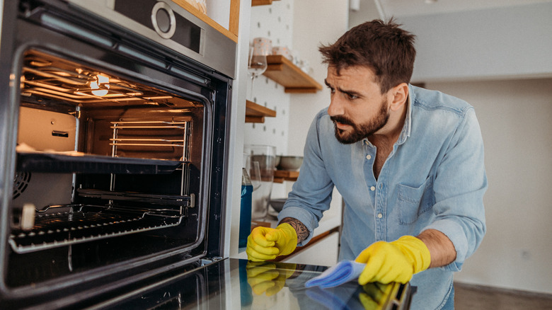 Man inspecting clean oven