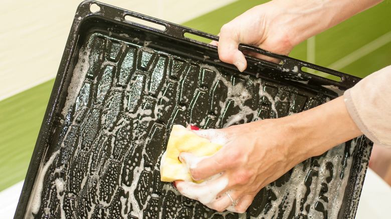 Woman washing tray with soap