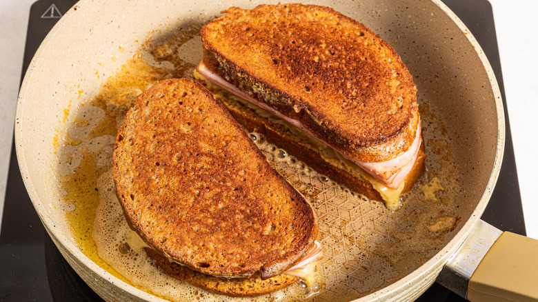 Two sandwiches cooked on a skillet
