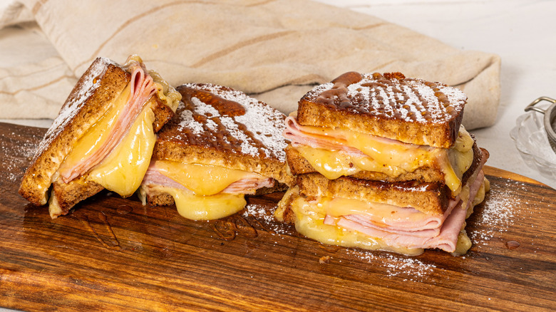 Sliced Monte Cristo sandwiches with honey and powder sugar on top