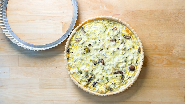 Mushroom and leek quiche removed from tart pan on counter top