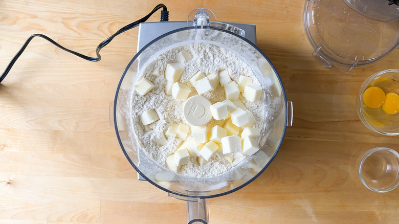 Butter cubes and flour in food processor bowl