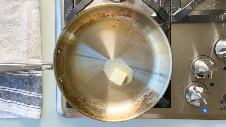 Butter melting in saute pan on stove