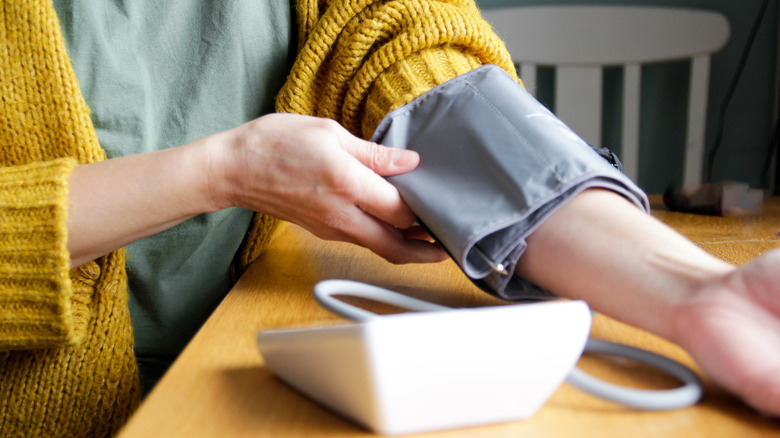 Woman measuring her blood pressure