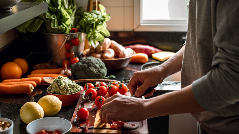 Man chopping vegetables in kitchen