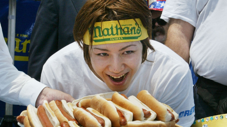 Takeru Kobayashi with pile of hot dogs