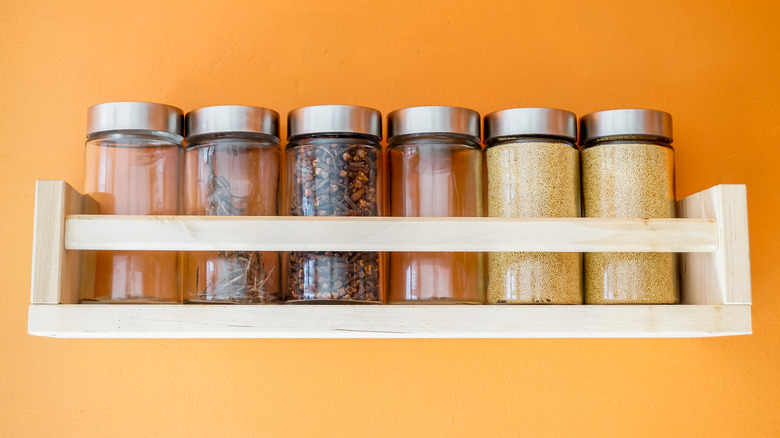 Spices in jars on rack