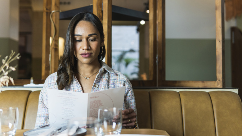 woman reading a menu