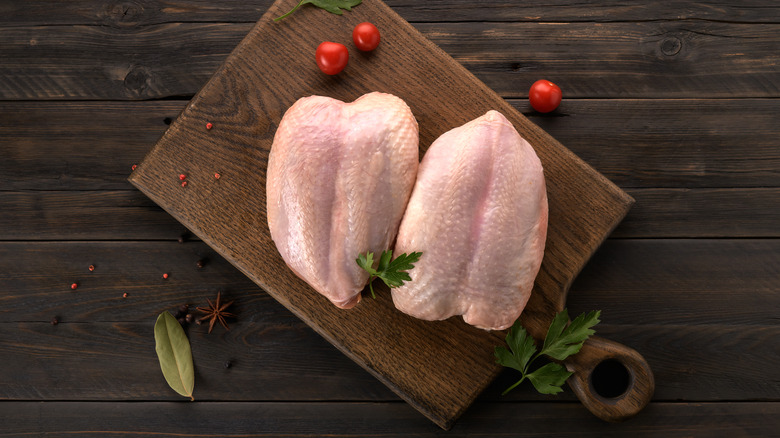 Bone-in, skin-on raw chicken breast
