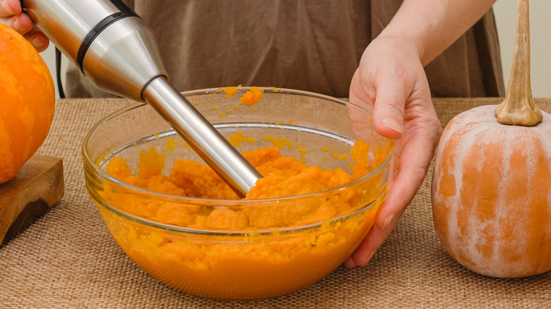 Person making homemade pumpkin puree