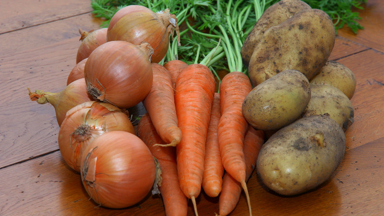 onions, carrots and potatoes on table