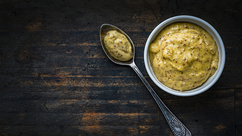 dijon mustard on spoon and bowl