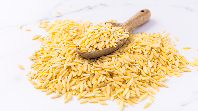 isolated spoonful of orzo on marble table