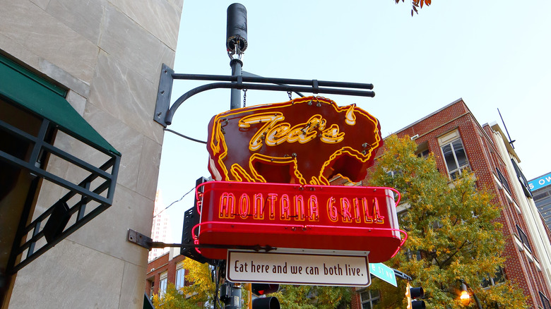 A Ted's Montana Grill sign hangs from the wall of one of the chain restaurant's locations