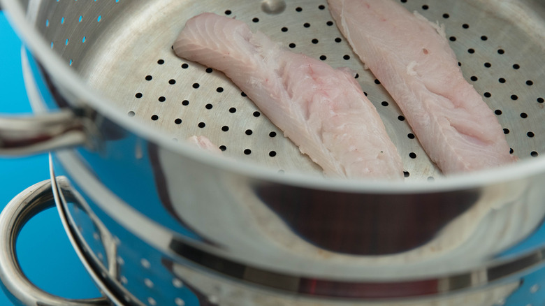 Pieces of fish inside a metal steamer insert