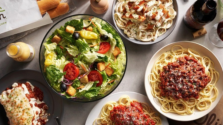 Multiple Olive Garden dishes spread on the table