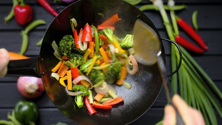 sauteeing vegetables in wok