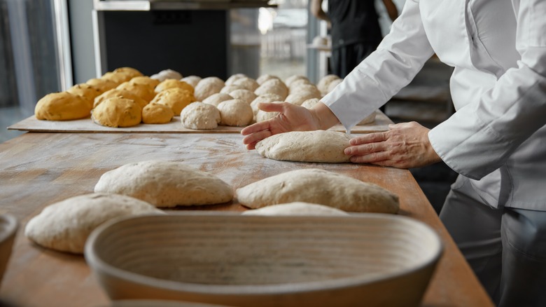 Baker shapes dough