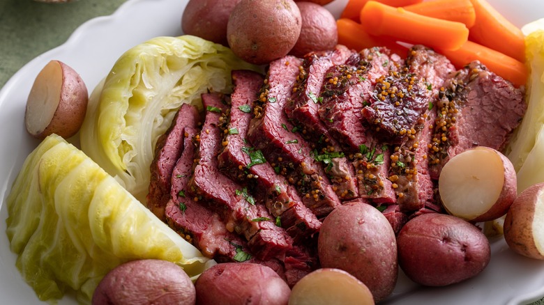 white tray with corned beef and cabbage