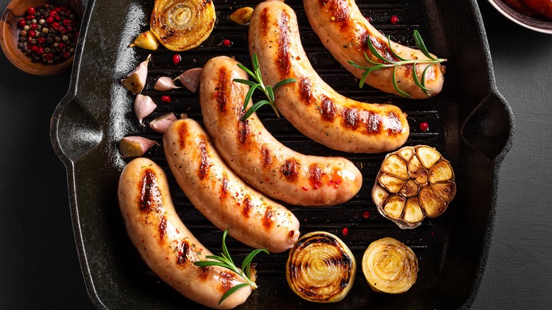 Grilled sausage and garlic in a skillet