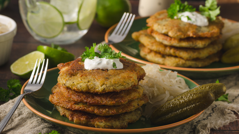 Latkes served with pickles and sauerkraut