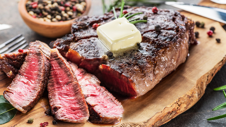 Organic ribeye with butter and peppercorns