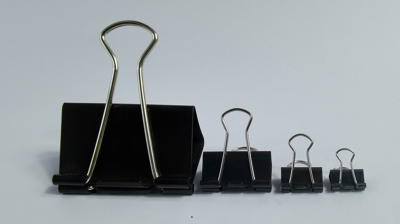 Various sizes of black binder clips