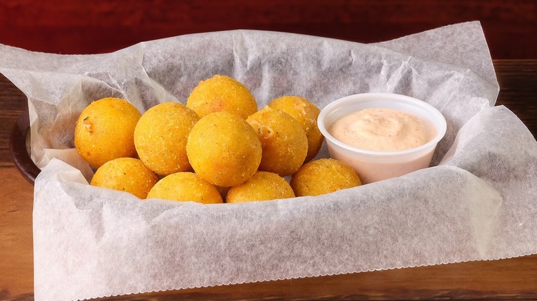 Texas Roadhouse's rattlesnake bites appetizer in basket with sauce