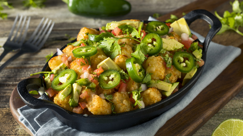 Tater tots with jalapenos and avocado are on display.