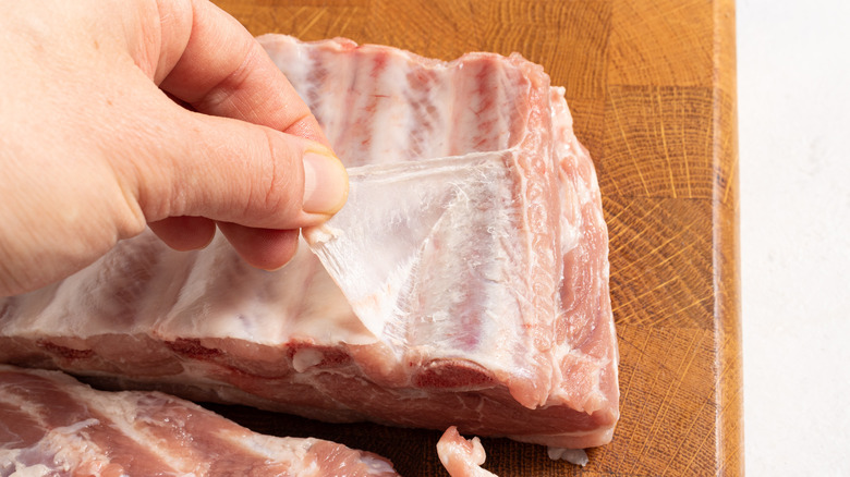 Peeling a thin membrane from baby ribs