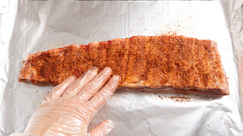Rubbing spices onto ribs