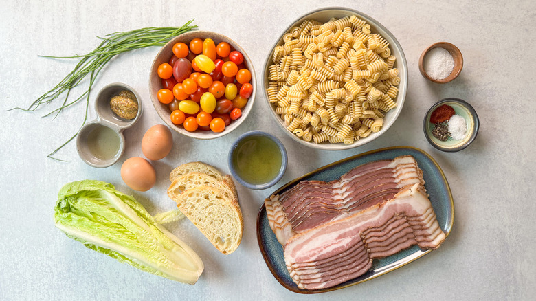 Over-the-top BLT pasta salad ingredients on countertop